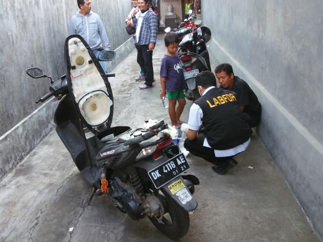 Police check a motorbike at the Kubu Kauh Beach Inn in Kuta. Picture: Supplied