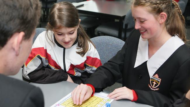 Year 10 students help Year 3 students with maths. Picture: Ian Svegovic