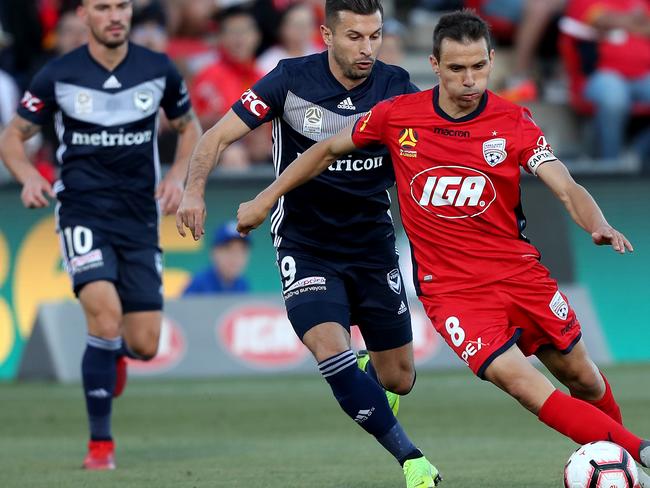 ADELAIDE, AUSTRALIA - JANUARY 09: Kosta Barbarouses of Melbourne Victory tackles Isaias of Adelaide United during the round 12 A-League match between Adelaide United and the Melbourne Victory at Coopers Stadium on January 09, 2019 in Adelaide, Australia. (Photo by James Elsby/Getty Images)