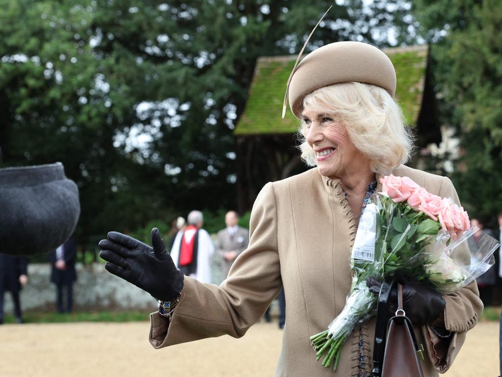 Queen Camilla waves to wellwishers after attending the Royal Family's traditional Christmas Day service. Her children have been invited to Christmas at Sandringham. Picture: AFP