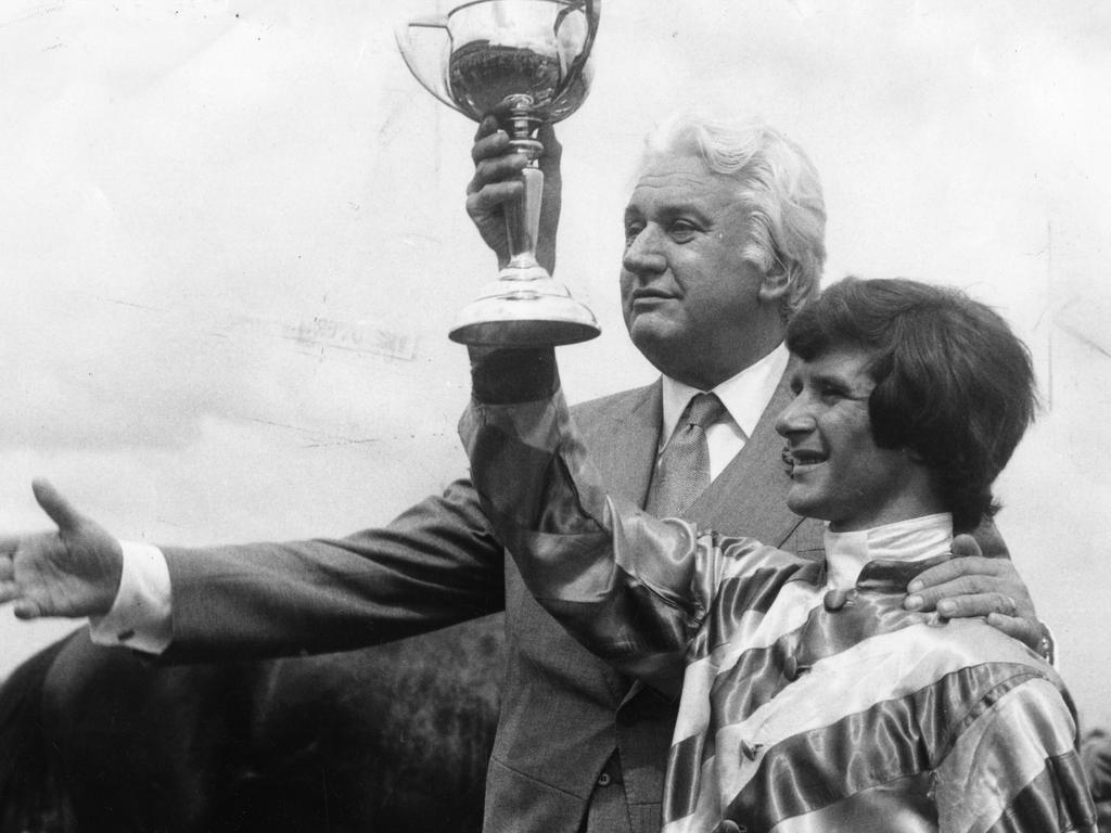 Governor-General Sir John Kerr puts his arm around victorious jockey John Duggan.