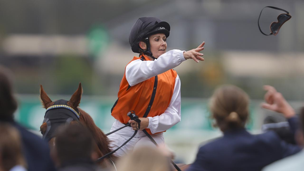 Rachel King throws her goggles into the crowd after winning the Festival Stakes on Ellsberg. Picture: Getty Images