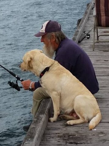 Les Modra with Reggie the Labrador. Picture: supplied