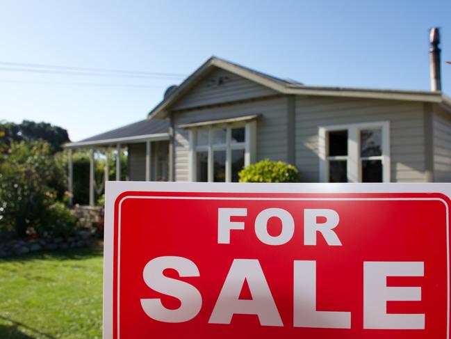 A For Sale Sign Outside a House.