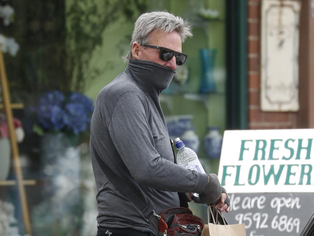 Newman was seen pulling his turtle neck over his mouth instead of wearing a mask. Picture: MEDIA-MODE.COM