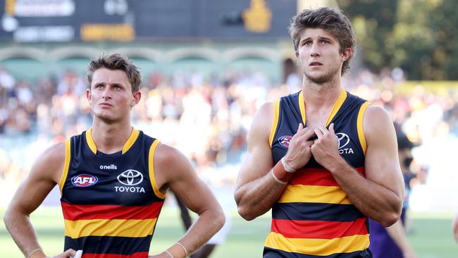 Matt Crouch and Jordon Butts after the final siren. Picture: Sarah Reed/AFL Photos via Getty Images