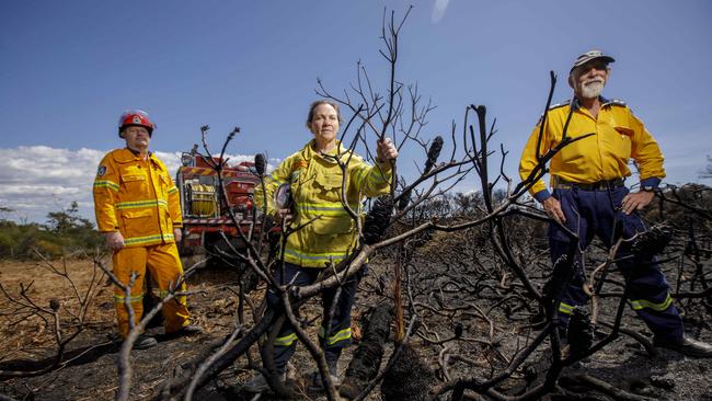 NSW RFS volunteers Ron Lynch, left, Pam Zaccagnini and Vic Walker on the outskirts of Currarong, where a hazard reduction burn got out of control. Picture: Sean Davey