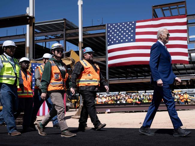 TOPSHOT - US President Joe Biden arrives with union members to speak after touring Intel's Ocotillo Campus in Chandler, Arizona, on March 20, 2024. The White House unveiled almost $20 billion in new grants and loans Wednesday to support Intel's US chip-making facilities, marking the Biden administration's largest funding announcement yet as it tackles China's dominance of the crucial technology. (Photo by Brendan Smialowski / AFP)