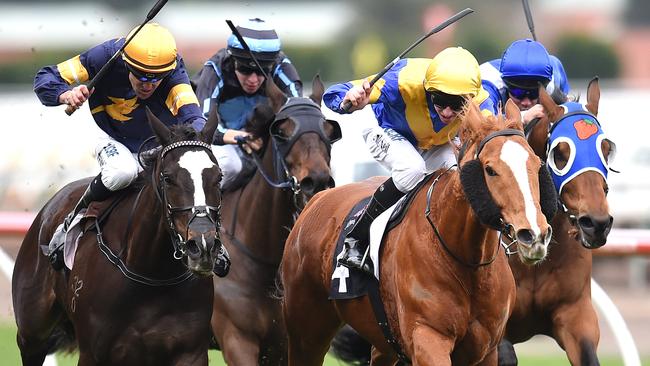 Flemington Races. Race 6 winner 'Play Master' with jockey Jye McNeil (Royal blue with gold V, chevron arm bands and cap, second from right). Picture: Jason Sammon