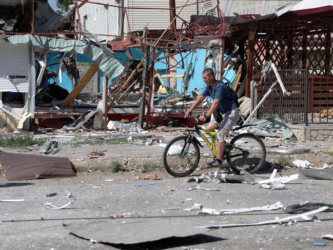 A man rides a bicycle among debris in Lysychansk as Ukraine says Russian shelling has caused "catastrophic destruction" in the eastern industrial city. Picture: AFP