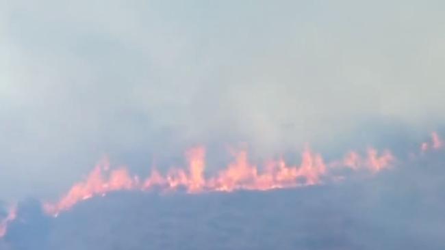 A bushfire ignited by lightning near Kilcoy is putting homes under threat. Picture: 7 News