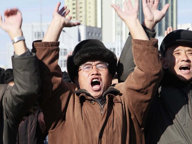 People cheer as they watch the news broadcast announcing Kim Jong-un’s order to test-fire the newly developed intercontinental ballistic missile Hwasong-15. Picture: Jon Chol Jin/AP