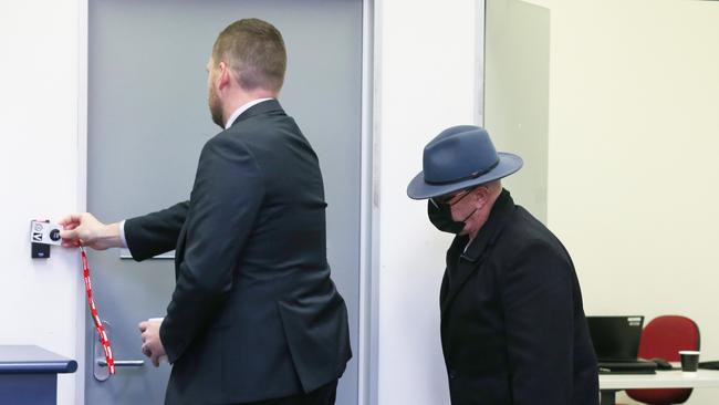 Robert Silkman being escorted into an interview room by detectives at Bankstown police station to give evidence in the Chris Dawson trial. Picture: John Feder/The Australian