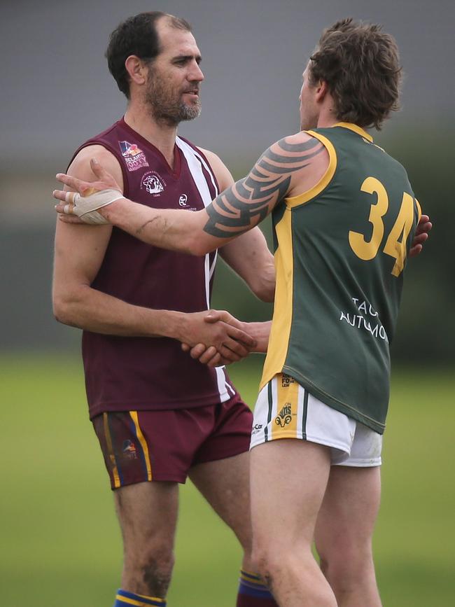 Trevor Rigney is congratulated by Marion’s Dean Saunders for kicking 100 goals on Saturday. Picture: AAP/Dean Martin.