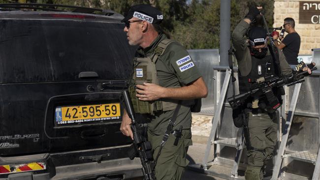 Israeli security forces secure a road near where Israel's government says a drone launched toward Israeli Prime Minister Benjamin Netanyahu's house in Caesarea, Israel Saturday, Oct. 19, 2024. (AP Photo/Ariel Schalit)