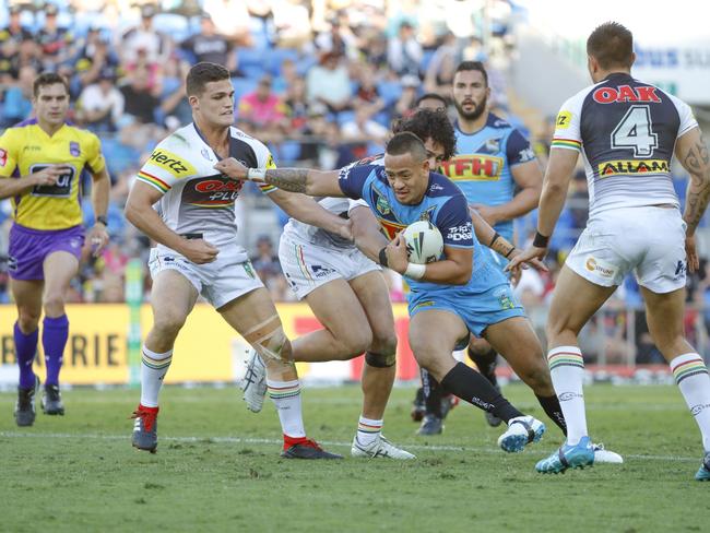 Phillip Sami of the Titans (centre) fends off a tackle from Corey Harawira-Naera (second left) and Nathan Cleary (left) of the Panthers during the Round 22 NRL match between the Gold Coast Titans and the Penrith Panthers at Cbus Super Stadium on the Gold Coast, Saturday, August 11, 2018. Picture: AAP Image/Glenn Hunt
