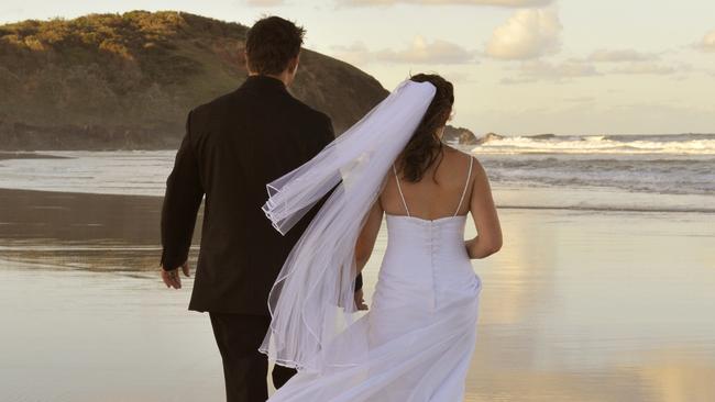 Generic image of bride and groom on a beach. From iStock.