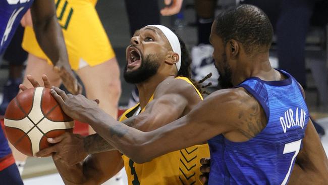 Patty Mills of the Australia Boomers is fouled by Kevin Durant