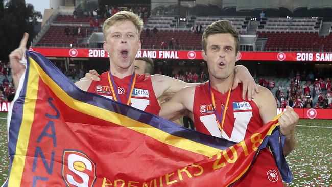 Maris Olekalns (left) and celebrates North Adelaide’s 2018 grand final win with Jarred Allmond. Olekalns will play for Adelaide University this season. Picture: Sarah Reed