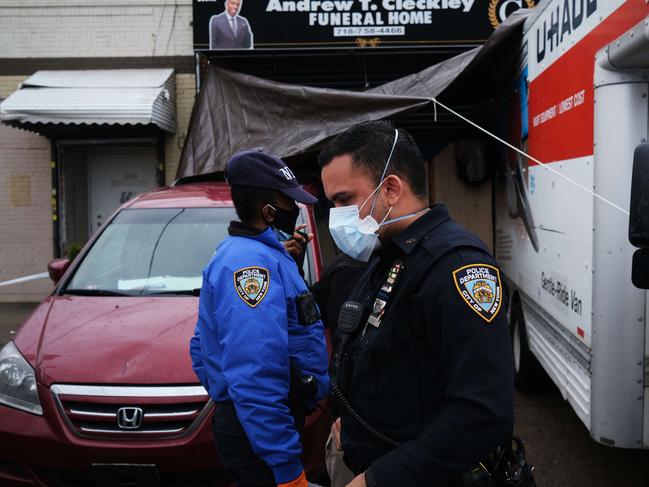 Police at the scene where dozens of bodies were found in unrefrigerated trucks outside of a New York funeral home. Picture: Getty Images/AFP