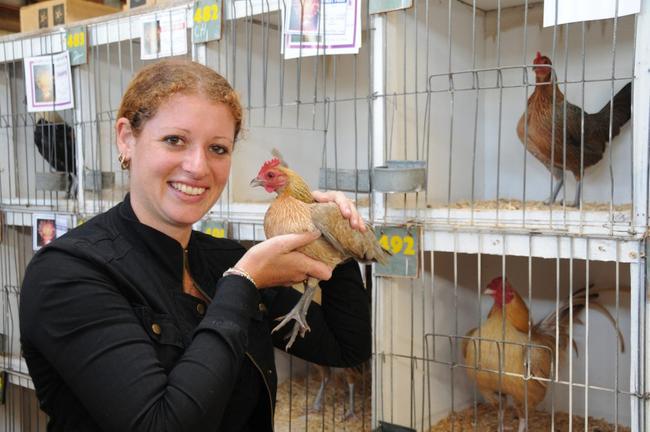 Michelle Baker proudly holding her Old English Game Blue Red Champion Hen. Picture: Renee Pilcher