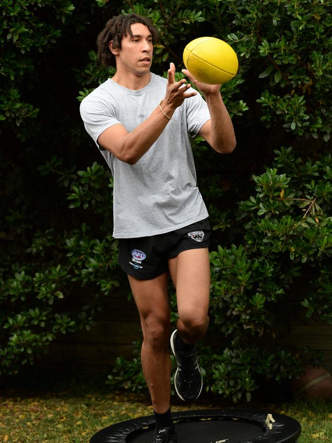 Aiden Bonar works on the trampoline to strengthen his legs. Picture: Lawrence Pinder