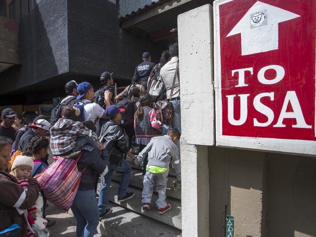 TIJUANA, MEXICO - APRIL 29: Members of a caravan of Central Americans who spent weeks traveling across Mexico walk from Mexico to the U.S. side of the border to ask authorities for asylum on April 29, 2018 in Tijuana, Baja California Norte, Mexico. More than 300 immigrants, the remnants of a caravan of Central Americans that journeyed across Mexico to ask for asylum in the United States, have reached the border to apply for legal entry.   (Photo by David McNew/Getty Images)