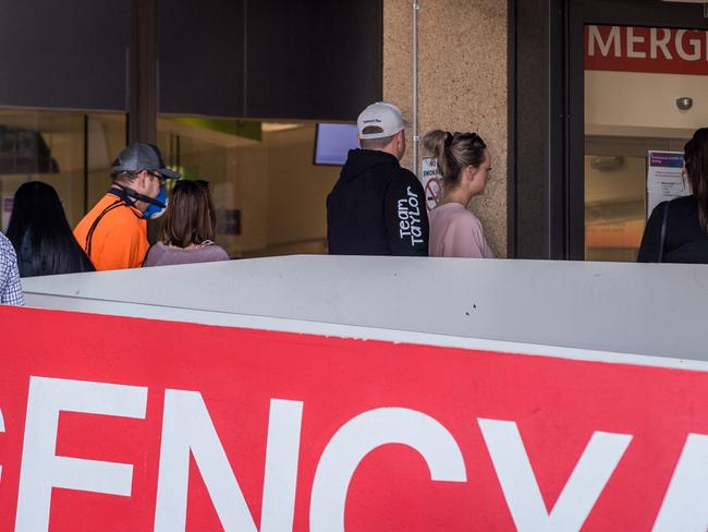 People queue for a fever clinic at Sunshine Hospital, Melbourne. Picture: Jake Nowakowski