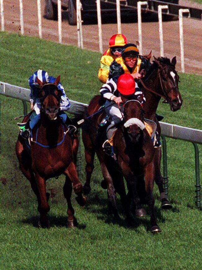 Ray Cochrane (red cap) on Taufan’s Melody impedes Chris Munce on Jezabeel (inside) before Taufan’s Melody went on to win the 1998 Caulfield Cup.