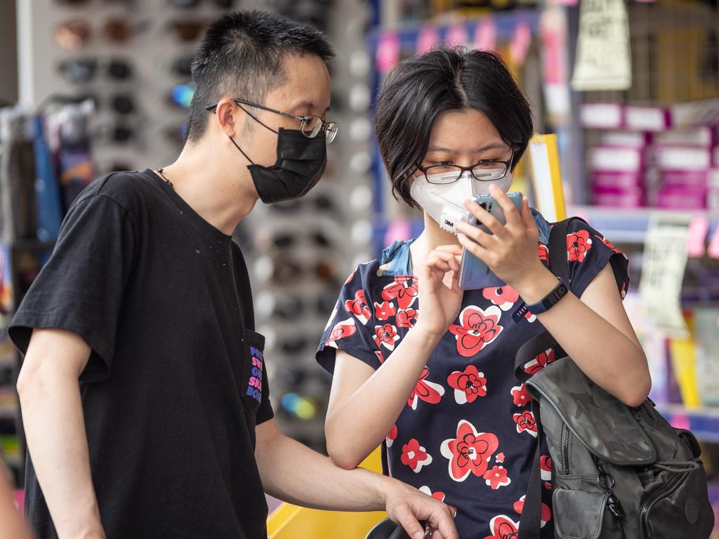 People in the Sydney suburb of Eastwood cover their faces on Saturday. Picture: Julian Andrews