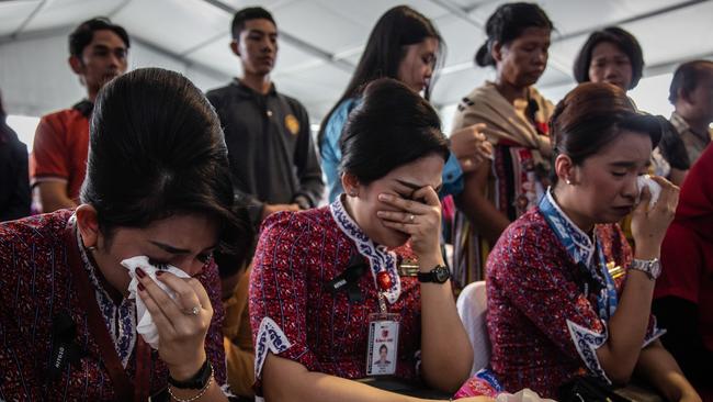 Colleagues of victims of Lion Air flight cry on deck of Indonesian Navy ship KRI Banjarmasin during visit and pray at the site of the crash.