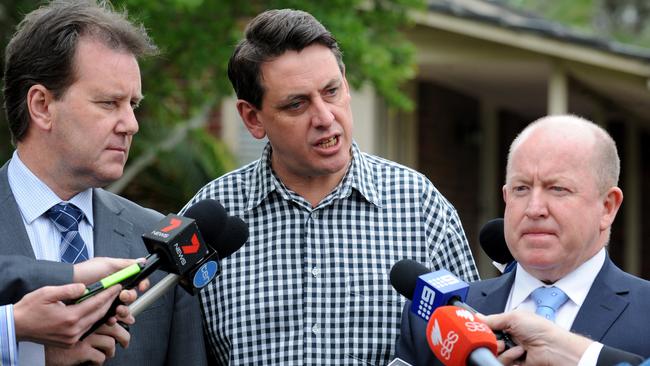 A defiant Bailey (centre) with Racing Victoria’s Dayle Brown and Bernard Saundry outside his home after the shots were fired. Picture: Andrew Henshaw