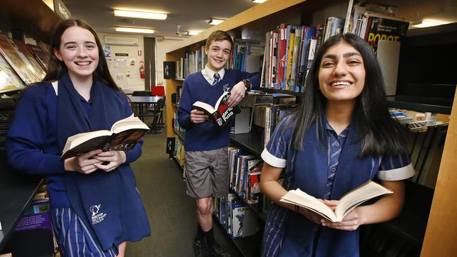 Year 9 students from Melton Secondary College - Chloe, Ace and Pardis - enjoy the school’s reading program. Picture: David Caird