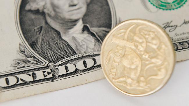 A 1 Australian Dollar coin and a 1 US Dollar note are seen in Canberra, Tuesday, May 21, 2013. As the US economy rebounds, there are predictions that the Australian dollar could fall as low as 90 US cents in the coming weeks and months. (AAP Image/Lukas Coch) NO ARCHIVING