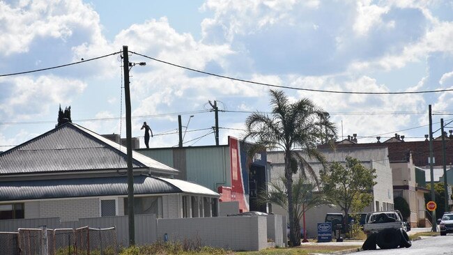 The now 32-year-old spent about 10 hours on a Warwick business roof, where he threatened to 'gut' police.