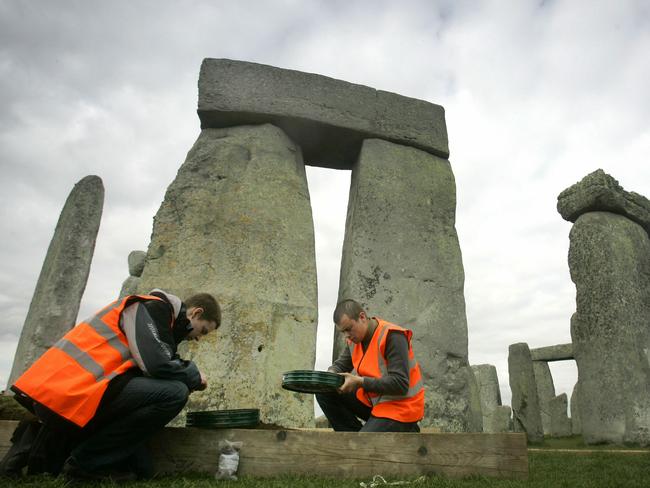 Archaeology students sieve through earth among the stones at Stonehenge, March 2008.