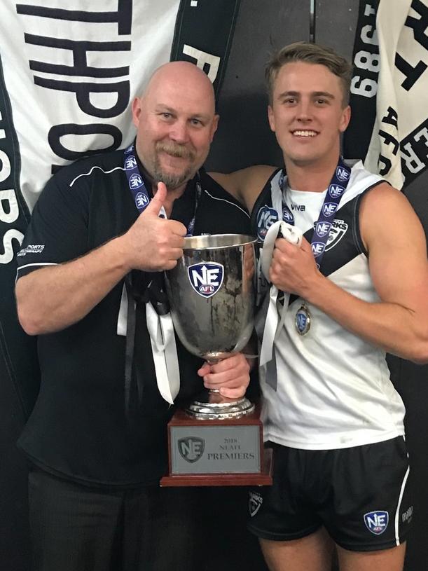 Southport Sharks coach Steve Daniel and player Michael Manteit celebrate the 2018 NEAFL premiership in their first season at the club. Picture: Southport Sharks.