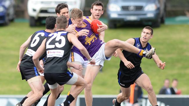 Uni Blacks players pounce on Collegians’ Sam Hibbins.  Picture: Susan Windmiller