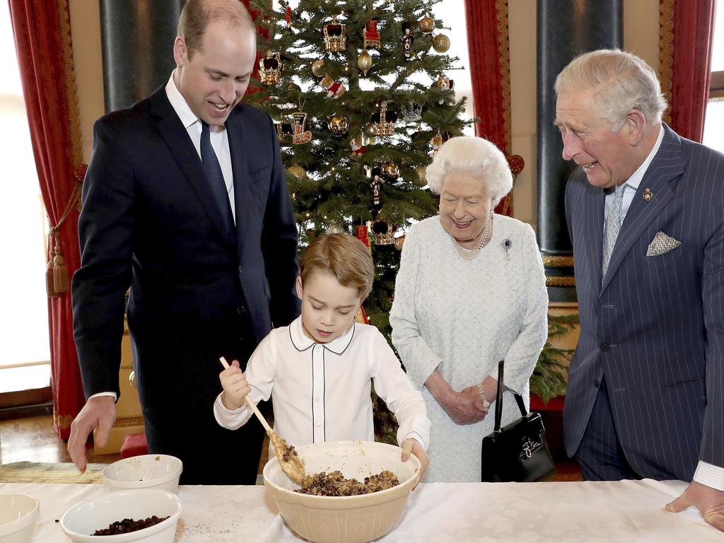 A Christmas image showing Britain's Queen Elizabeth, Prince Charles, Prince William and Prince George preparing Christmas puddings. Picture: Chris Jackson/Buckingham Palace via AP.