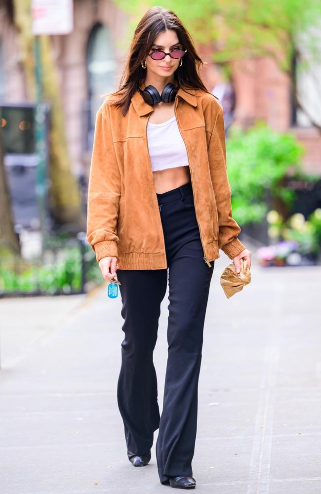 It defies expectation but looking at this, it turns out Emily Ratajkowski eats muffins - would never have guessed. Anyway, she also looked fabulous in this tan jacket paired with a white crop top and flared pants. Picture: BACKGRID Australia