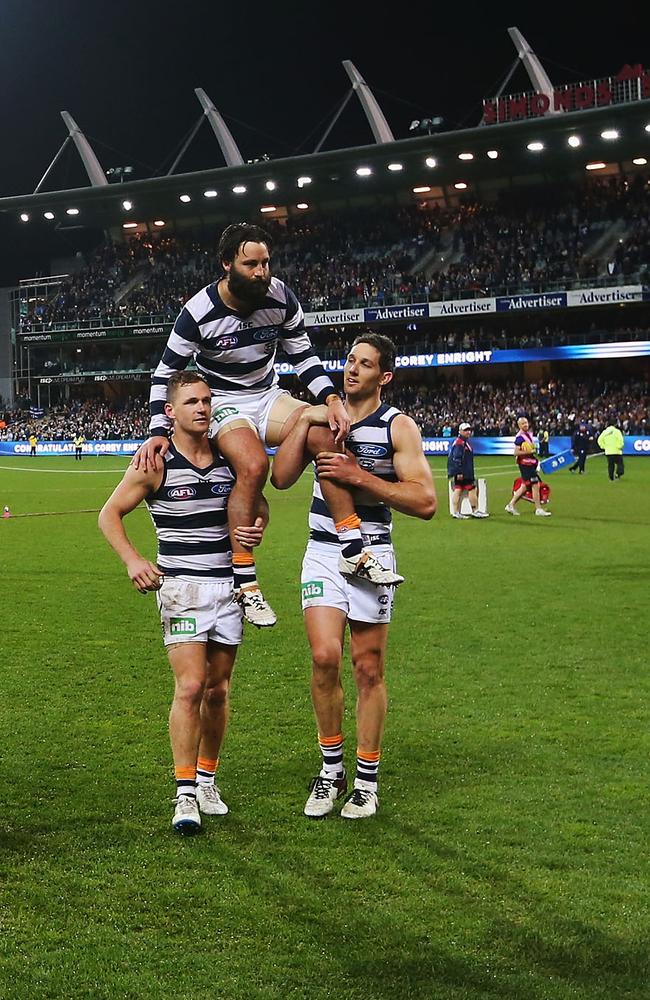 Jimmy is chaired off the ground by great mates Joel Selwood and Harry Taylor after booting the last goal in his 300th game. Picture: Getty Images