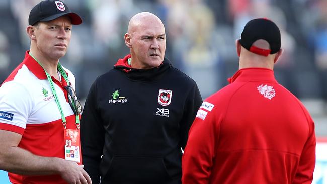 SYDNEY, AUSTRALIA - JUNE 08: Dragons coach Paul McGregor and Dragons assistant coach Shane Flanagan speak to other members of the team staff on the field ahead of the round four NRL match between the Canterbury Bulldogs and the St George Illawarra Dragons at Bankwest Stadium on June 08, 2020 in Sydney, Australia. (Photo by Mark Kolbe/Getty Images)