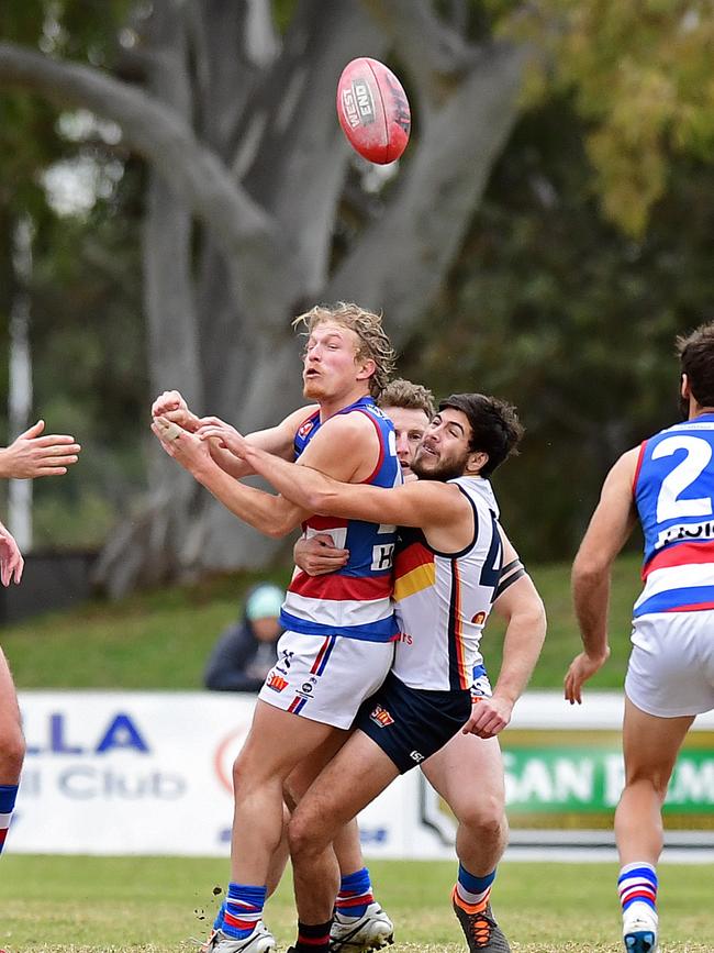 Central’s Travis Schiller is tackled by Adelaide’s Ben Jarman. Picture: Tom Huntley.