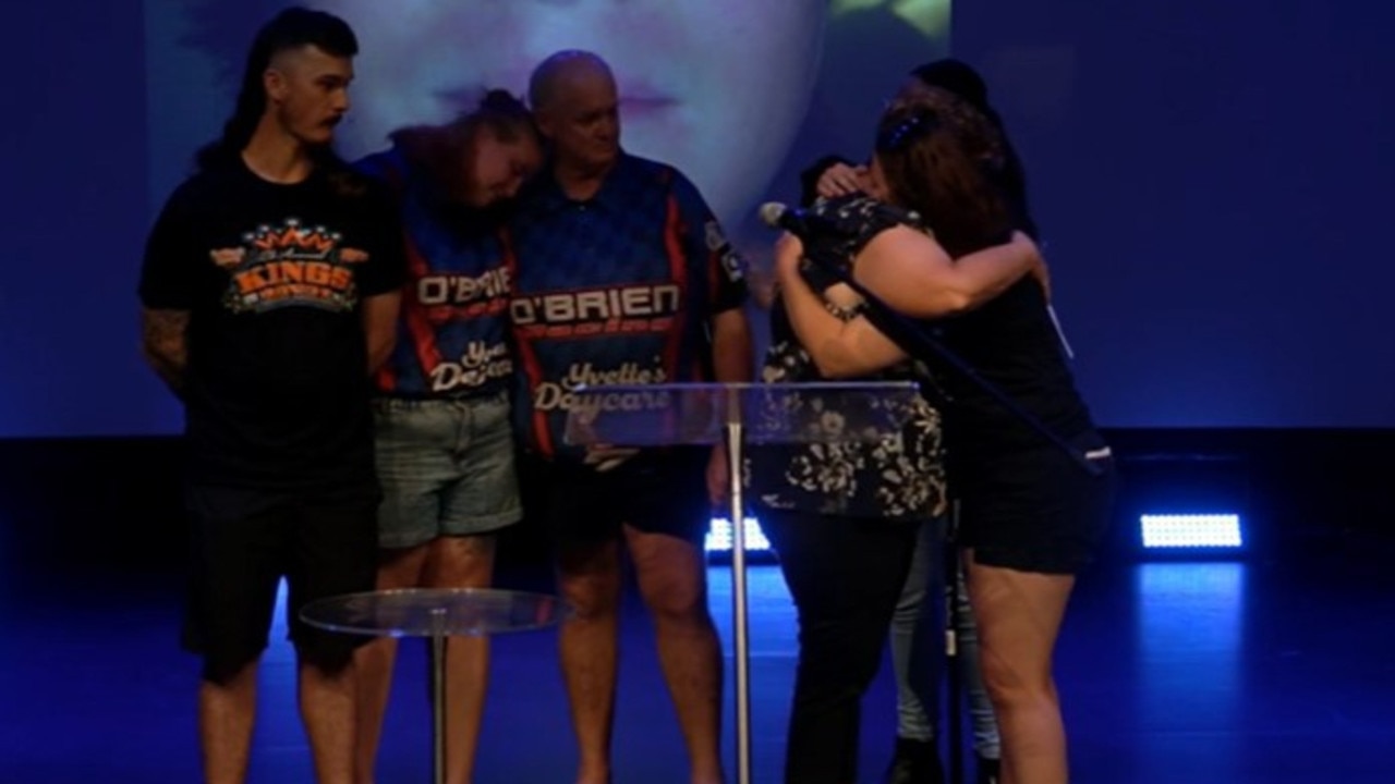 Luke O'Brien's mother Yvette receiving a comforting hug from Morgan Miles, Mr O'Brien's partner, during his funeral service on Friday, February 2, 2024. In the background is Luke's brother Chae O'Brien,, sister Krystall O'Brien, and father Terry O'Brien.