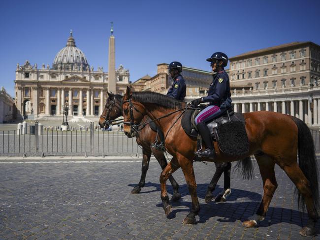 Mounted police patrol empty St. Peter's Square in Rome. Picture: AP