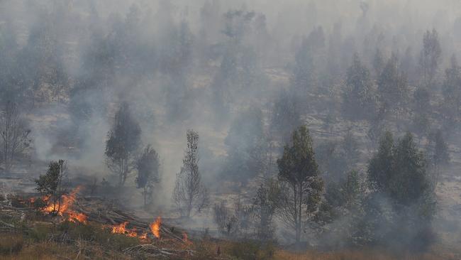 Smoke and burnt out bushland above Castle Forbes Bay this morning. Picture: RICHARD JUPE