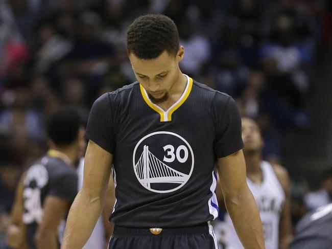 Golden State Warriors' Stephen Curry looks down during the second half of an NBA basketball game against the Milwaukee Bucks Saturday, Dec. 12, 2015, in Milwaukee. The Bucks won 108-95. (AP Photo/Aaron Gash)