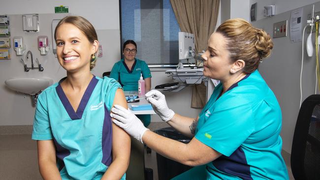 Registered Nurse Zoe Park receives the first Covid-19 vaccine from clinical nurse consultant Kellie Kenway at Gold Coast University Hospital on February 22, 2021 in Southport, Australia. Picture: Nigel Hallett-Pool