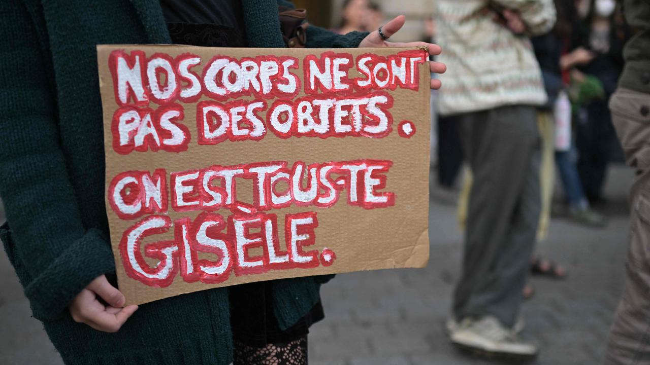 A protester holds a placard reading "Our bodies are not objects. We are all Gisele". Picture: Damien Meyer/AFP