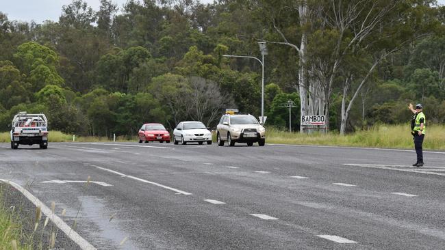 Two people were when a car rolled on the Bruce Highway near Bells Bridge on Friday morning, causing highway traffic delays.